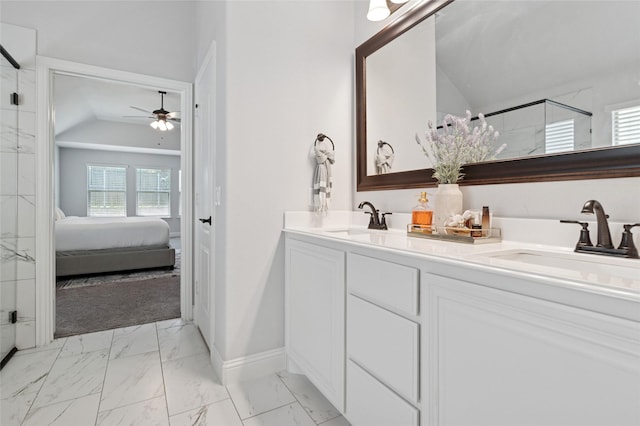 ensuite bathroom featuring marble finish floor, a ceiling fan, a sink, and a stall shower