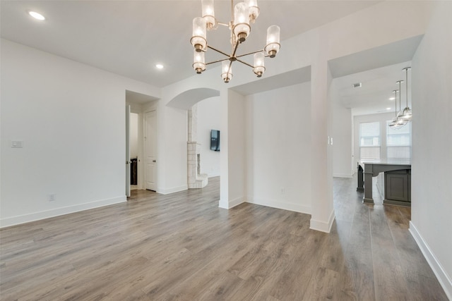4600 Paintbrush Way, Aubrey, TX 76227 - interior space featuring recessed lighting, light wood-style floors, arched walkways, and a notable chandelier
