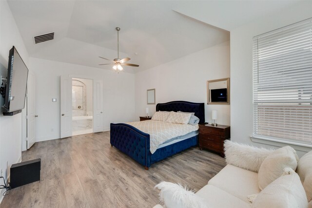 4600 Paintbrush Way, Aubrey, TX 76227 - bedroom with vaulted ceiling, multiple windows, wood finished floors, and visible vents