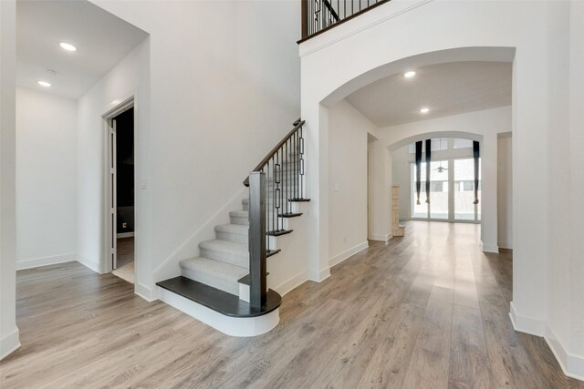 4600 Paintbrush Way, Aubrey, TX 76227 - foyer entrance featuring wood finished floors, stairs, arched walkways, baseboards, and recessed lighting