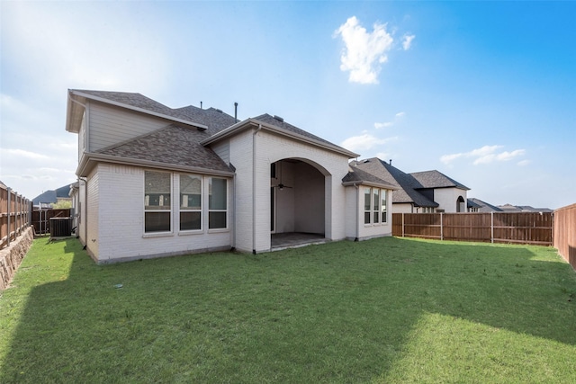 4600 Paintbrush Way, Aubrey, TX 76227 - rear view of house with a fenced backyard, brick siding, and a lawn