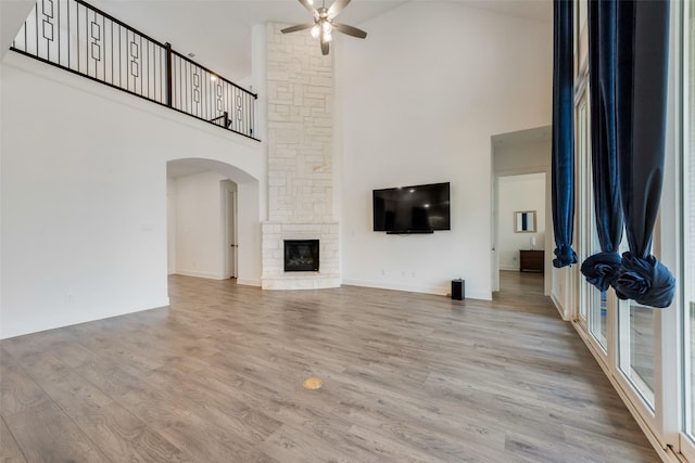 4600 Paintbrush Way, Aubrey, TX 76227 - unfurnished living room featuring high vaulted ceiling, a ceiling fan, wood finished floors, arched walkways, and baseboards