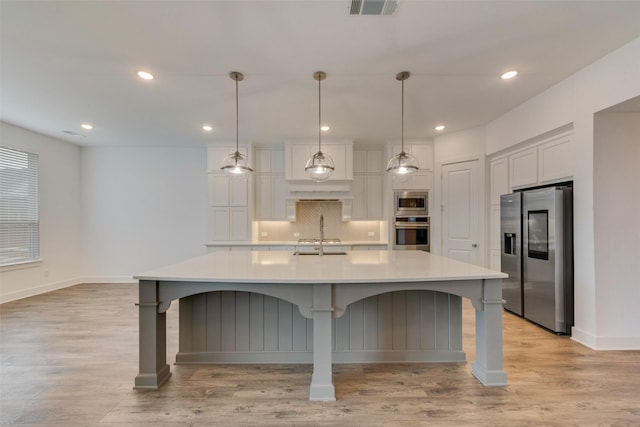 4600 Paintbrush Way, Aubrey, TX 76227 - kitchen featuring white cabinets, stainless steel appliances, backsplash, light countertops, and light wood-type flooring