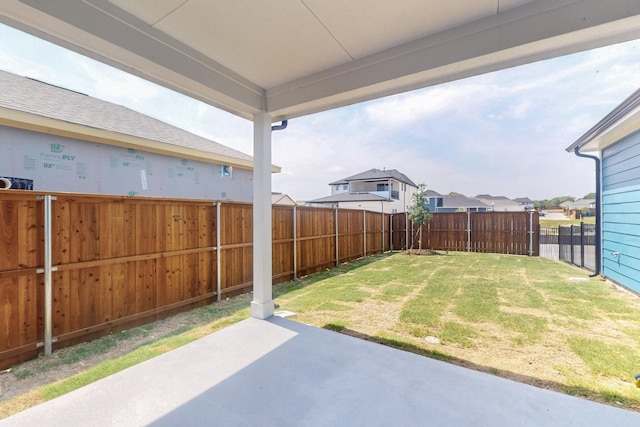 view of yard with a residential view, a patio area, and a fenced backyard
