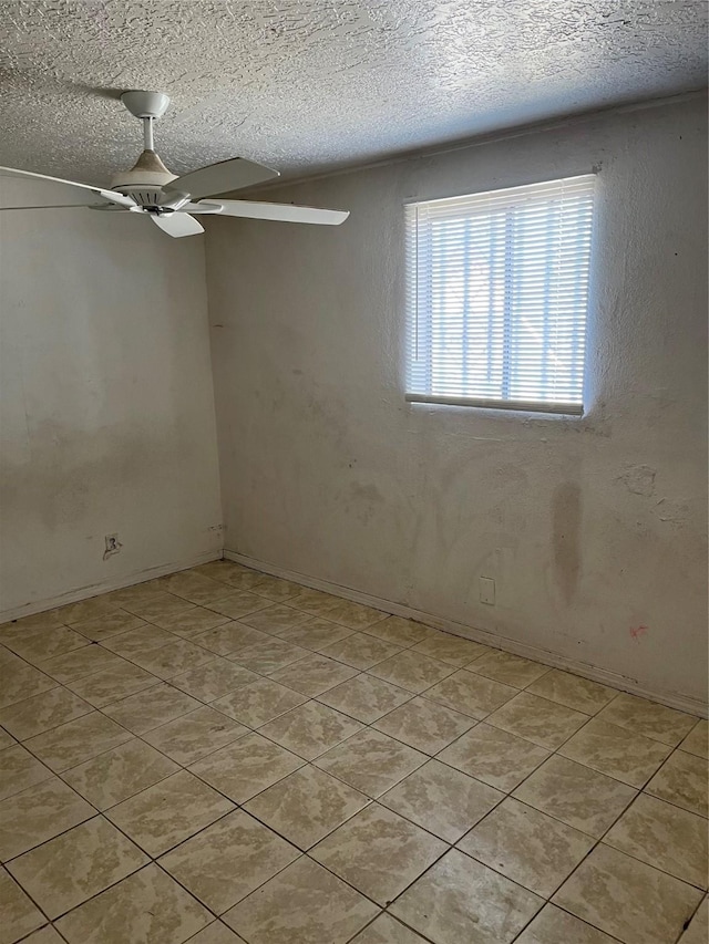 unfurnished room featuring a textured ceiling and ceiling fan