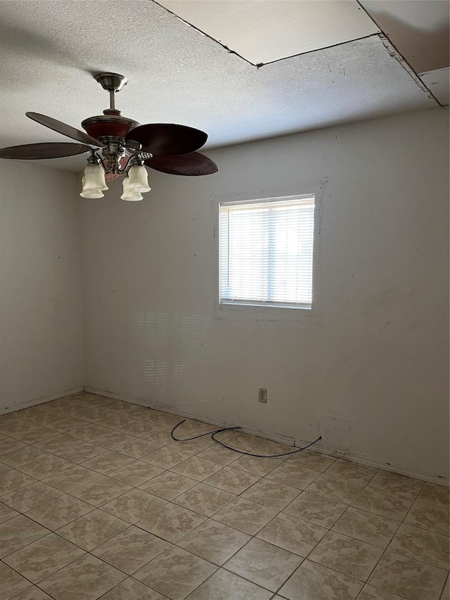 spare room featuring ceiling fan and a textured ceiling
