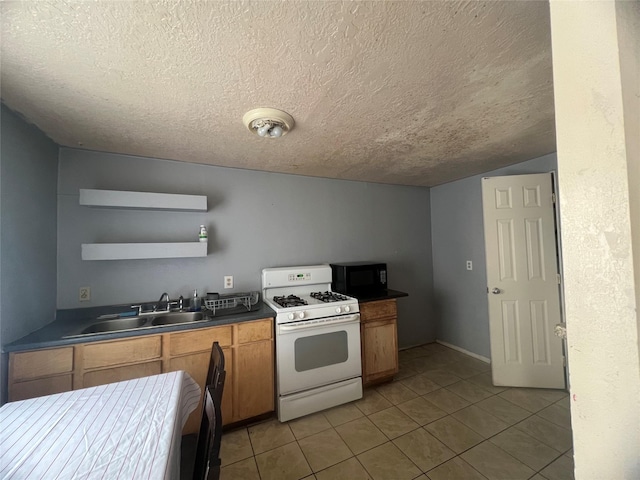 kitchen featuring white gas stove, open shelves, a sink, a textured ceiling, and black microwave