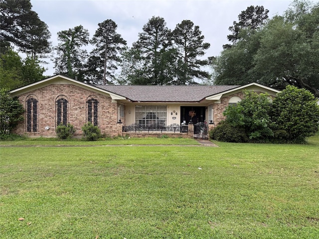 single story home with brick siding and a front yard