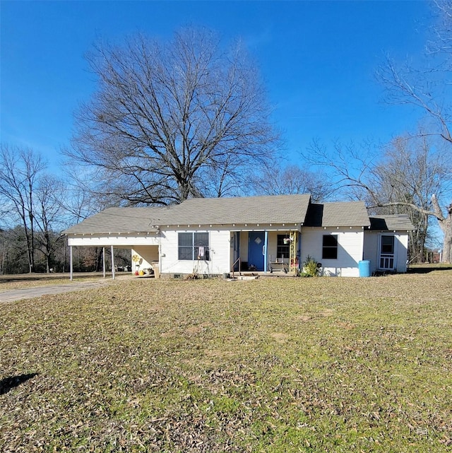 single story home with concrete driveway, a front lawn, and an attached carport