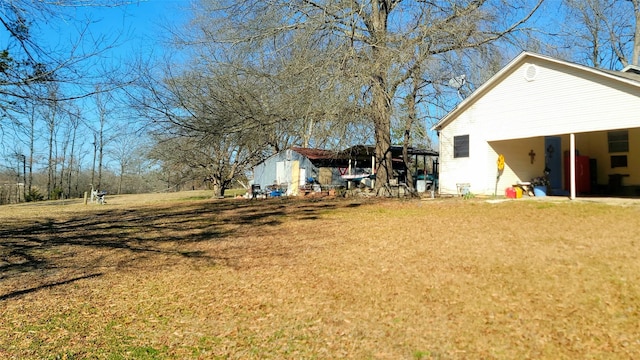 view of yard featuring an outbuilding and a shed