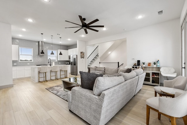 2635 Carmelita St, Dallas, TX 75212 - living area with a ceiling fan, light wood finished floors, stairway, and recessed lighting