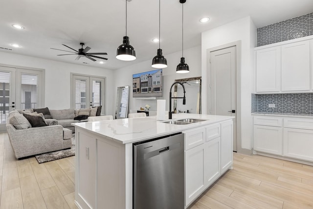 2635 Carmelita St, Dallas, TX 75212 - kitchen featuring stainless steel dishwasher, french doors, light wood-style floors, white cabinetry, and ceiling fan