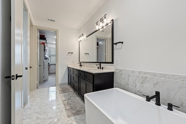 2635 Carmelita St, Dallas, TX 75212 - full bath with a soaking tub, double vanity, and marble tiled flooring