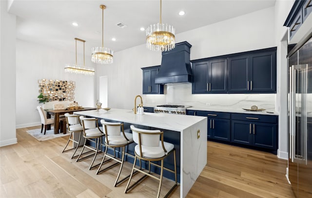 4120 Ridgecrest Dr, Flower Mound, TX 75022 - kitchen with blue cabinets, an inviting chandelier, decorative backsplash, custom range hood, and a breakfast bar