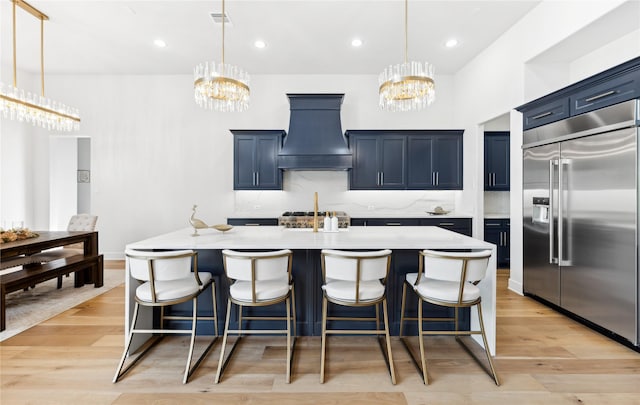 4120 Ridgecrest Dr, Flower Mound, TX 75022 - kitchen with built in fridge, light countertops, custom exhaust hood, and a notable chandelier