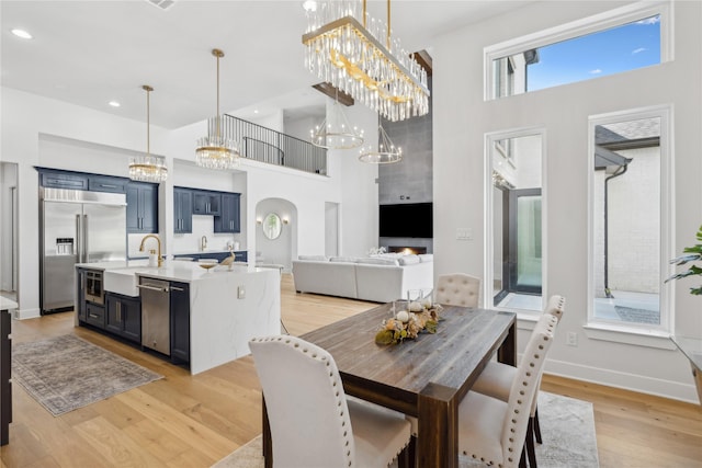 4120 Ridgecrest Dr, Flower Mound, TX 75022 - dining area with recessed lighting, a high ceiling, a chandelier, and light wood-style floors