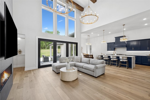 4120 Ridgecrest Dr, Flower Mound, TX 75022 - living room featuring beamed ceiling, a high ceiling, light wood finished floors, and a chandelier