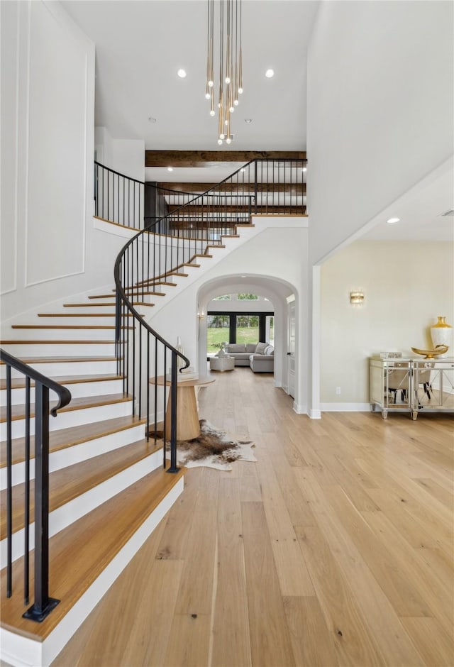 4120 Ridgecrest Dr, Flower Mound, TX 75022 - foyer entrance featuring a high ceiling, stairway, baseboards, arched walkways, and hardwood / wood-style flooring