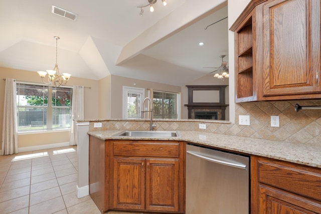 kitchen featuring stainless steel dishwasher, a sink, vaulted ceiling, visible vents, and light tile patterned floors