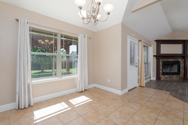 unfurnished dining area with vaulted ceiling, a chandelier, a tile fireplace, baseboards, and tile patterned flooring