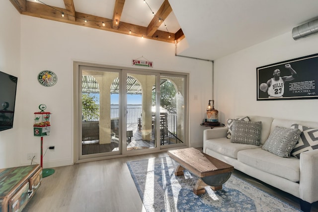 living room with baseboards, wood finished floors, and beamed ceiling