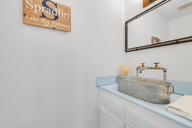 bathroom with visible vents and vanity