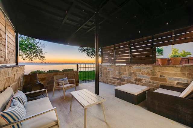 view of patio featuring a water view and an outdoor living space