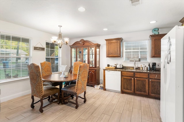 dining room with light wood finished floors, baseboards, a notable chandelier, visible vents, and recessed lighting