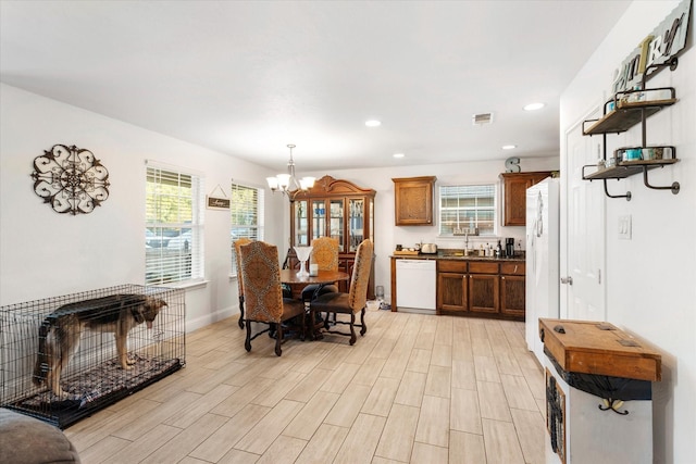 dining room featuring light wood-type flooring, visible vents, recessed lighting, and a notable chandelier