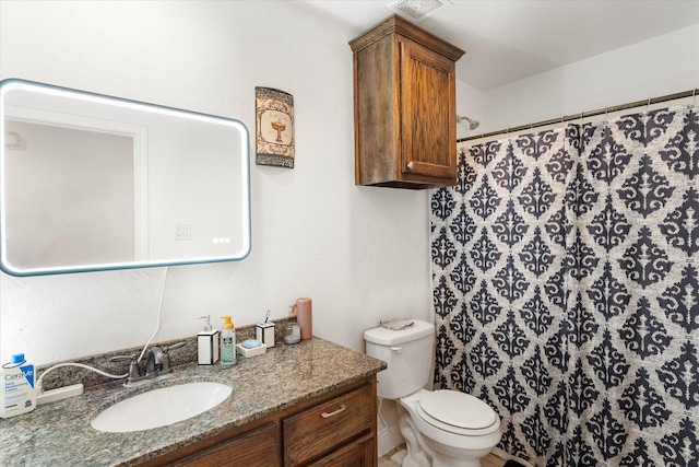 bathroom with visible vents, curtained shower, vanity, and toilet