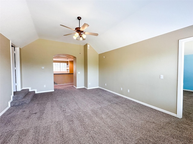unfurnished living room with arched walkways, carpet floors, lofted ceiling, and ceiling fan