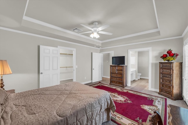 carpeted bedroom with baseboards, ornamental molding, a tray ceiling, and visible vents