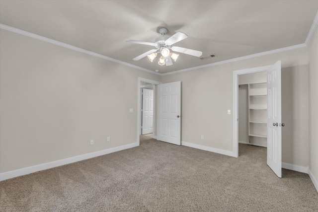 unfurnished bedroom with carpet floors, crown molding, visible vents, and baseboards