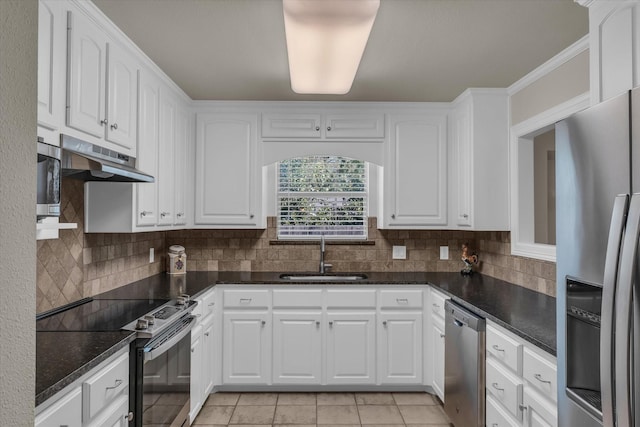 kitchen with white cabinets, decorative backsplash, stainless steel appliances, and a sink