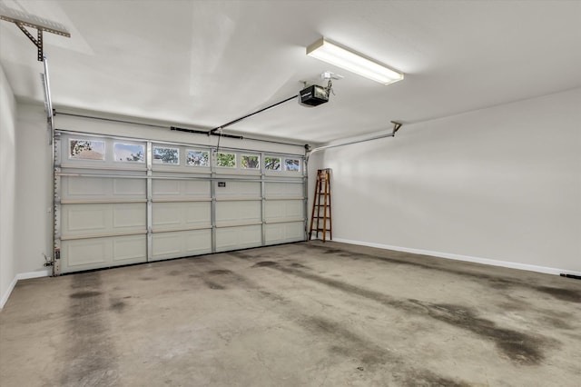 garage with a garage door opener and baseboards