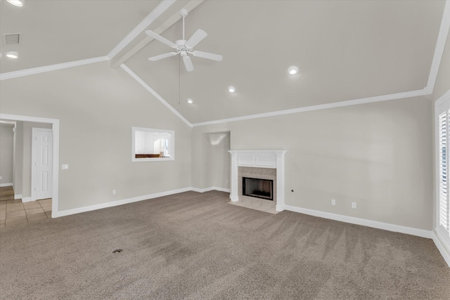 unfurnished living room with a tile fireplace, a ceiling fan, beamed ceiling, carpet floors, and baseboards