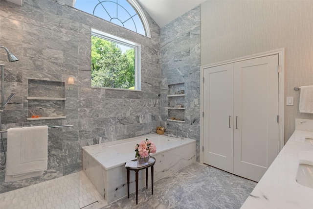1747 Crescent Ln, Duncanville, TX 75137 - bathroom featuring lofted ceiling, a tile shower, a garden tub, marble finish floors, and tile walls