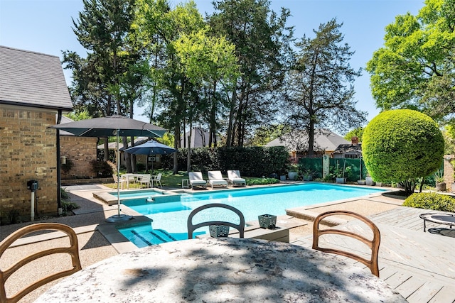 1747 Crescent Ln, Duncanville, TX 75137 - view of swimming pool with a pool with connected hot tub, fence, and a patio