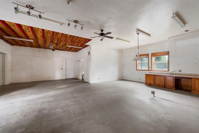 interior space with concrete floors and ceiling fan