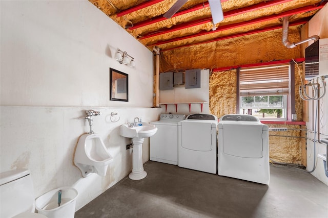 clothes washing area with electric panel, laundry area, and independent washer and dryer