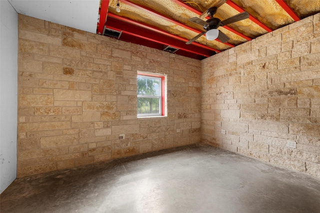 empty room with a ceiling fan, visible vents, and concrete floors