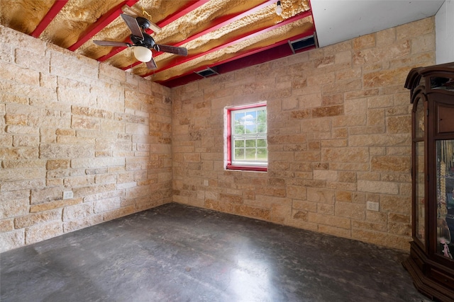 spare room with concrete floors, visible vents, and ceiling fan