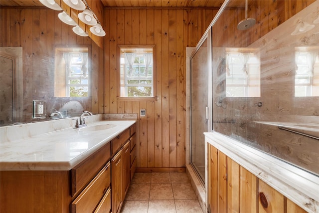 bathroom with tile patterned floors, vanity, wood walls, and a shower stall