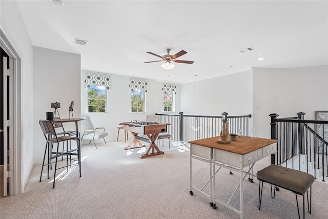 office area with carpet, visible vents, and a ceiling fan