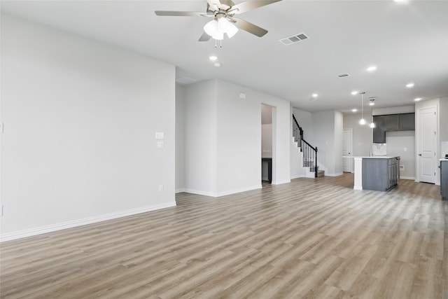 817 Hadley Dr, Princeton, TX 75071 - unfurnished living room with recessed lighting, light wood-type flooring, stairway, and a ceiling fan