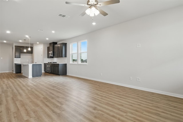 817 Hadley Dr, Princeton, TX 75071 - unfurnished living room featuring light wood-style flooring, recessed lighting, and a ceiling fan