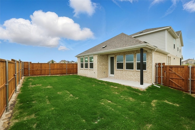 817 Hadley Dr, Princeton, TX 75071 - rear view of house featuring a fenced backyard, roof with shingles, brick siding, and a patio
