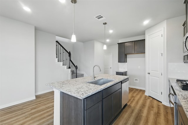 817 Hadley Dr, Princeton, TX 75071 - kitchen with stainless steel appliances, light wood-type flooring, light stone countertops, and recessed lighting