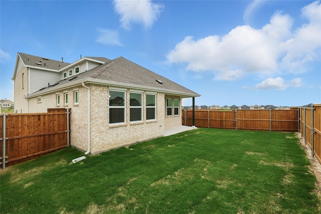 817 Hadley Dr, Princeton, TX 75071 - rear view of house with roof with shingles, brick siding, and a fenced backyard