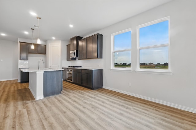817 Hadley Dr, Princeton, TX 75071 - kitchen featuring appliances with stainless steel finishes, light wood-style flooring, recessed lighting, decorative light fixtures, and dark brown cabinetry